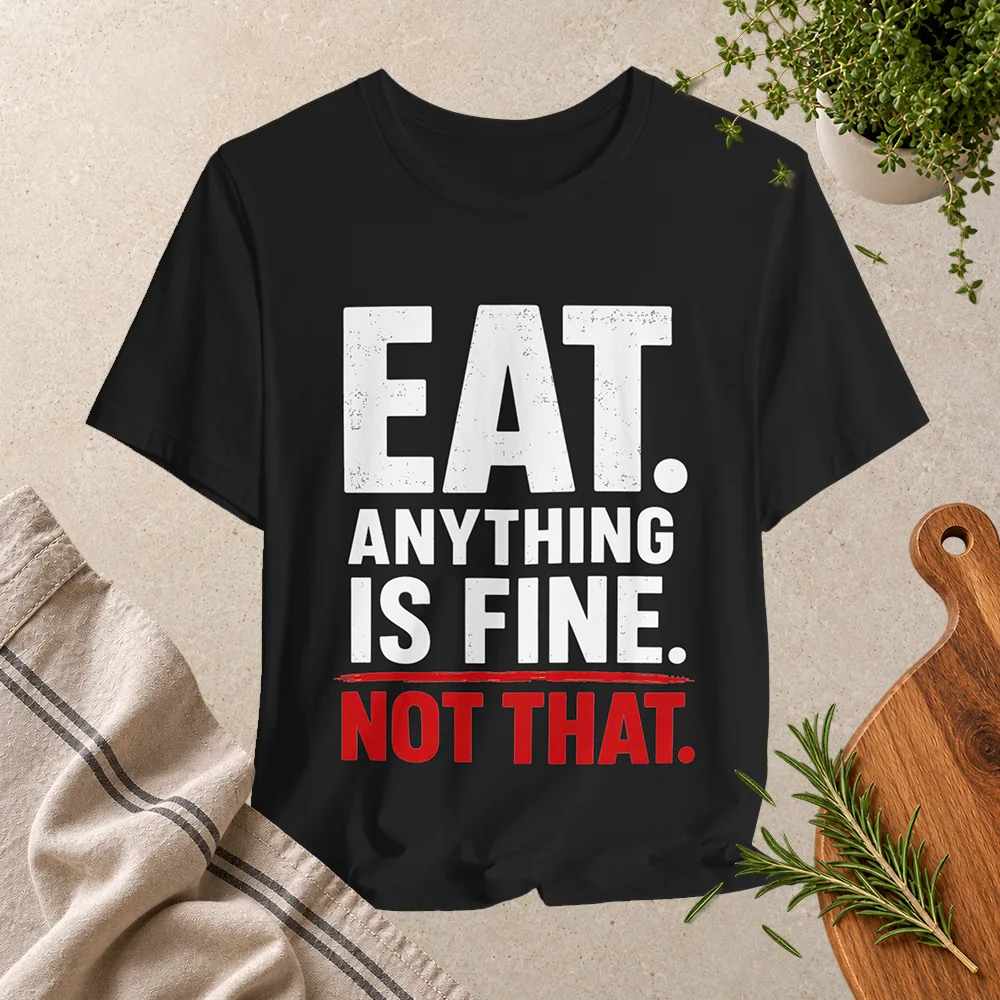 Black T-shirt with bold white and red typography reading “Eat. Anything is fine. Not that.”